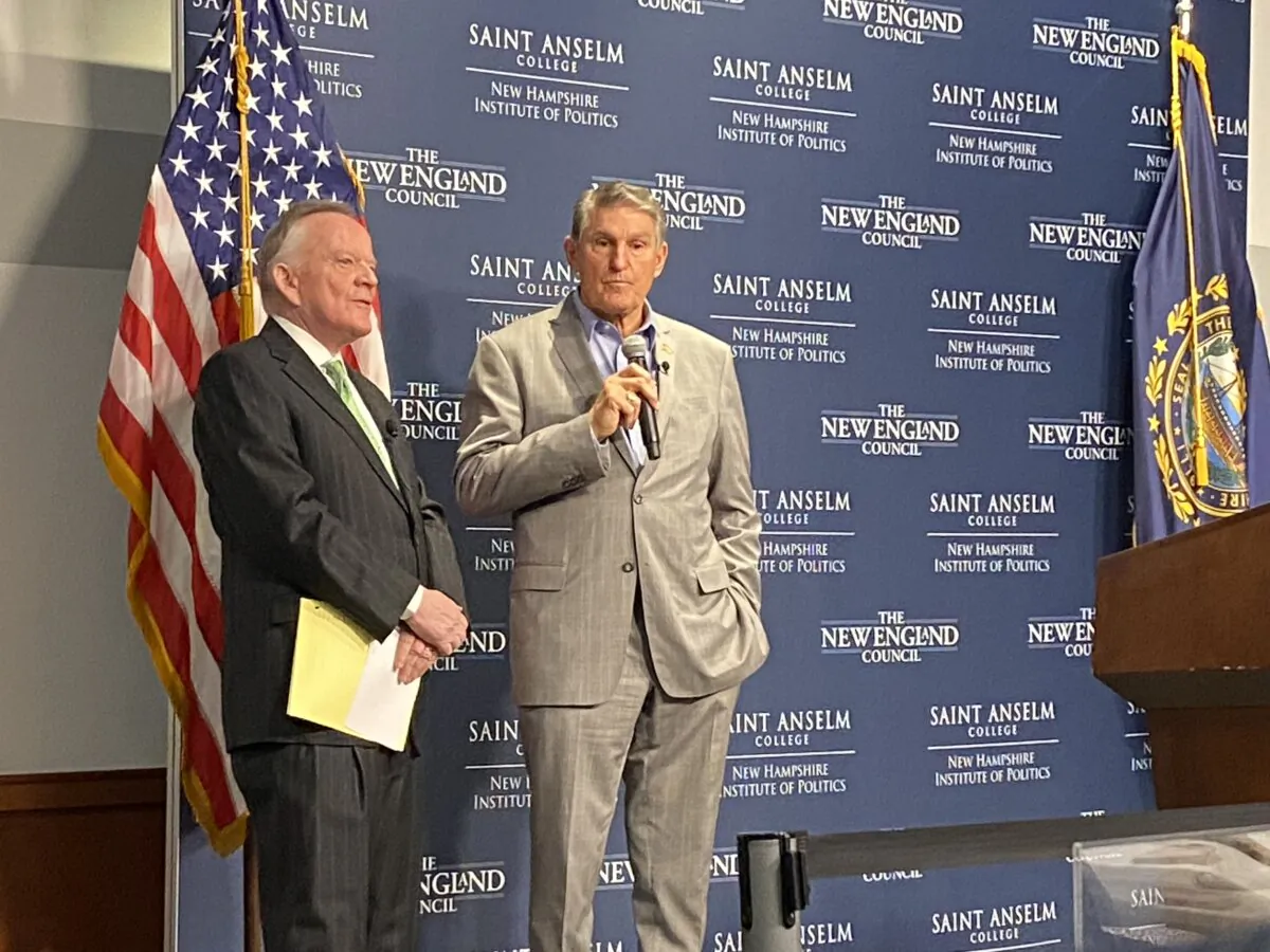 Sen Joe Manchin (D.-W.V.) with President James Brett of The New England Council on stage for the St. Anselm annual 'Politics & Eggs' breakfast, on Jan 12, 2023. (Alice Giordano)
