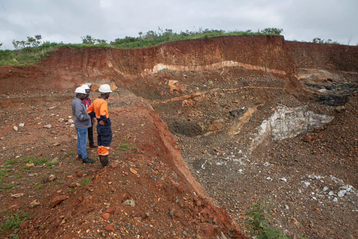 Workers inspect an open cast at the Arcadia lithium mine on Jan. 11, 2022, in Goromonzi, Zimbabwe. In 2023, the Chinese firm Zhejiang Huayou Cobalt said it would pay more than $400 million for the hard-rock lithium mine. (Tafadzwa Ufumeli/Getty Images)
