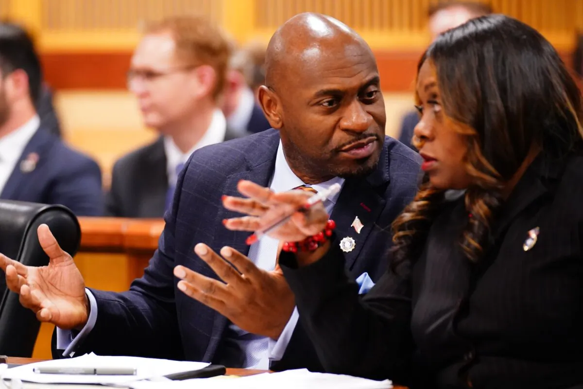 Fulton County special prosecutor Nathan Wade, left, and executive district attorney Daysha Young confer during a hearing in the 2020 Georgia election interference case at the Fulton County Courthouse in Atlanta on Dec. 1, 2023. (John David Mercer- Pool/Getty Images)