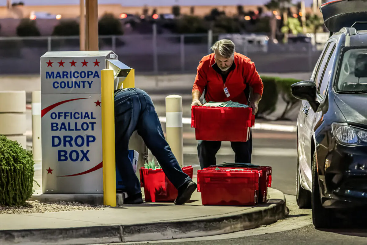 Maricopa County election workers remove ballots from a drop box in Mesa, Ariz., on Nov. 8, 2022. (John Moore/Getty Images)