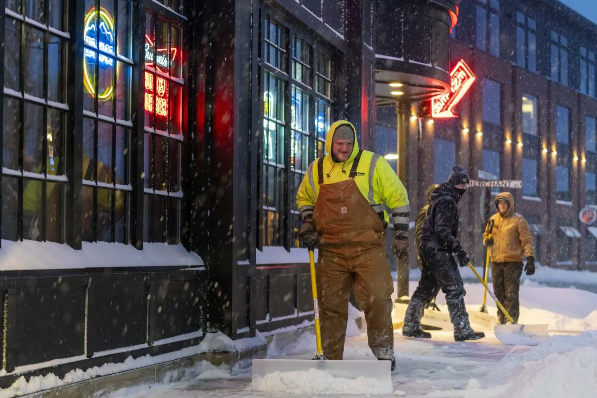 Workers shovel sidewalks in Ankeny, Iowa, on Jan. 12, 2024. (Andrew Harnik/AP Photo)