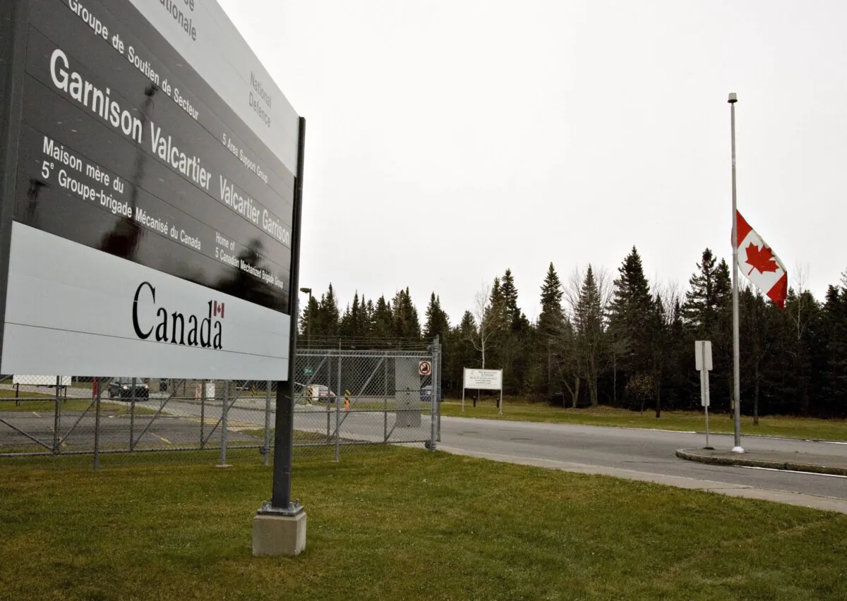 The Canadian flag flies at half mast at the entrance of CFB Valcartier, Que., on Nov. 17, 2007. (The Canadian Press/Jacques Boissinot)