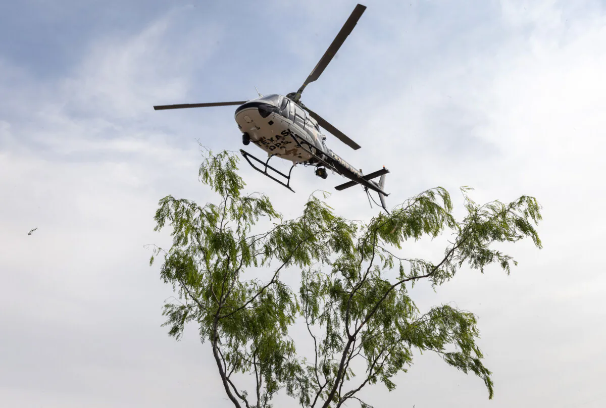A Texas Department of Public Safety (DPS) helicopter takes off near the U.S.–Mexico Border near Mission, Texas on March 23, 2021. (John Moore/Getty Images)