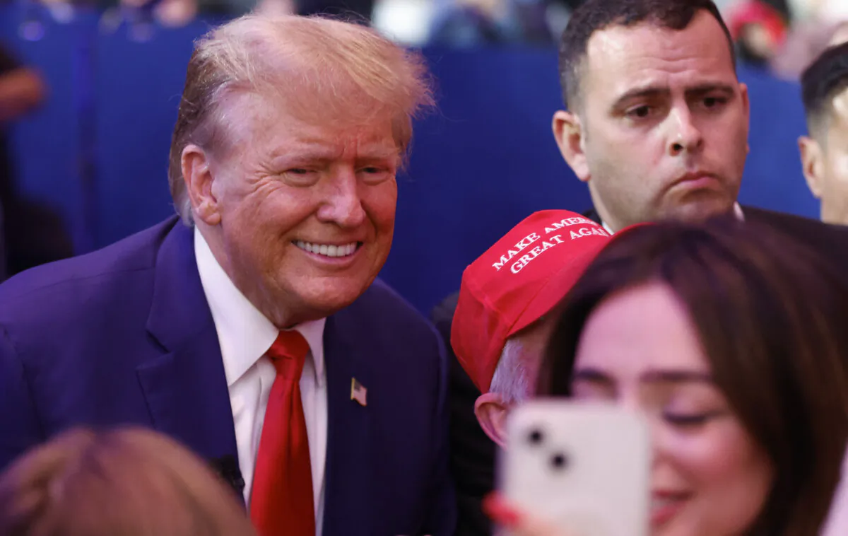 Former President and 2024 Republican presidential hopeful Donald Trump greets supporters as he leaves a town hall in Des Moines, Iowa, on Jan. 10, 2024. (Kamil Krzaczynski/AFP via Getty Images)
