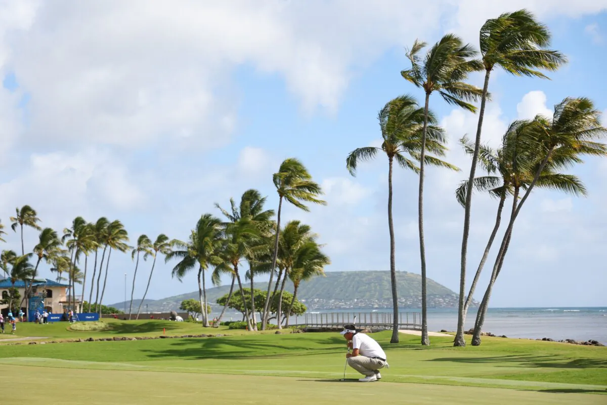 Carl Yuan of China lines up a putt on the 17th green during the second round of the Sony Open in Hawaii at Waialae Country Club in Honolulu, Hawaii, on Jan. 12, 2024. (Michael Reaves/Getty Images)