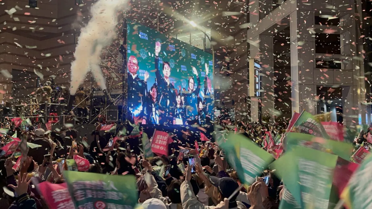 Supporters of Democratic Progressive Party presidential candidate Lai Ching-te celebrate the election returns in Taipei, Taiwan, on Jan. 13, 2024. (Melina Chan/The Epoch Times)