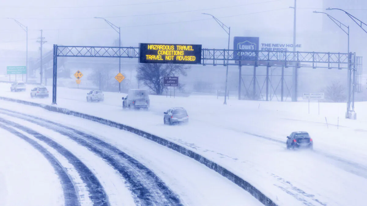 Signs along US Highway 75, looking south from F Street, advise against travel due to snow, in Omaha, Neb., on Jan. 12, 2024. (Chris Machian/Omaha World-Herald via AP)