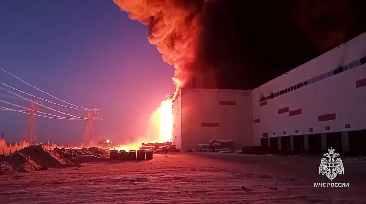 Russian Emergency Situations Ministry firefighters work at the side of the warehouse in St. Petersburg, Russia, In this photo released by Russian Emergency Ministry Press Service, on Jan. 13, 2024. (Russian Emergency Ministry Press Service via AP)