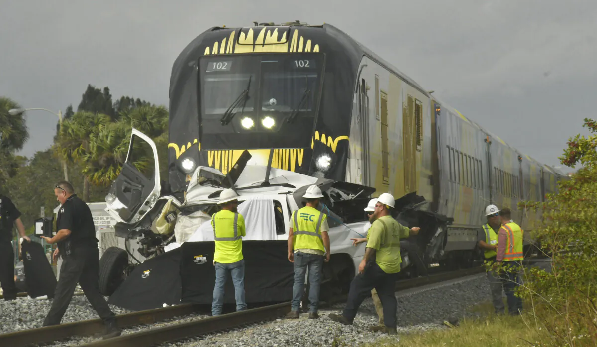 Emergency personnel work the scene of a fatal incident involving a vehicle and a Brightline train in Melbourne, Fla., on Jan.  12, 2024. (Tim Shortt/Florida Today via AP)