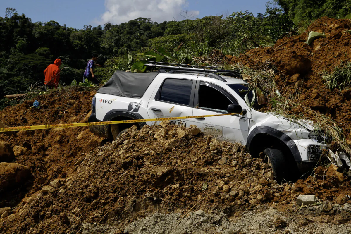 View of a wrecked car at the area of a landslide in the road between Quibdo and Medellin, Choco department, Colombia, on Jan. 13, 2024. (Fredy Builes/AFP via Getty Images)
