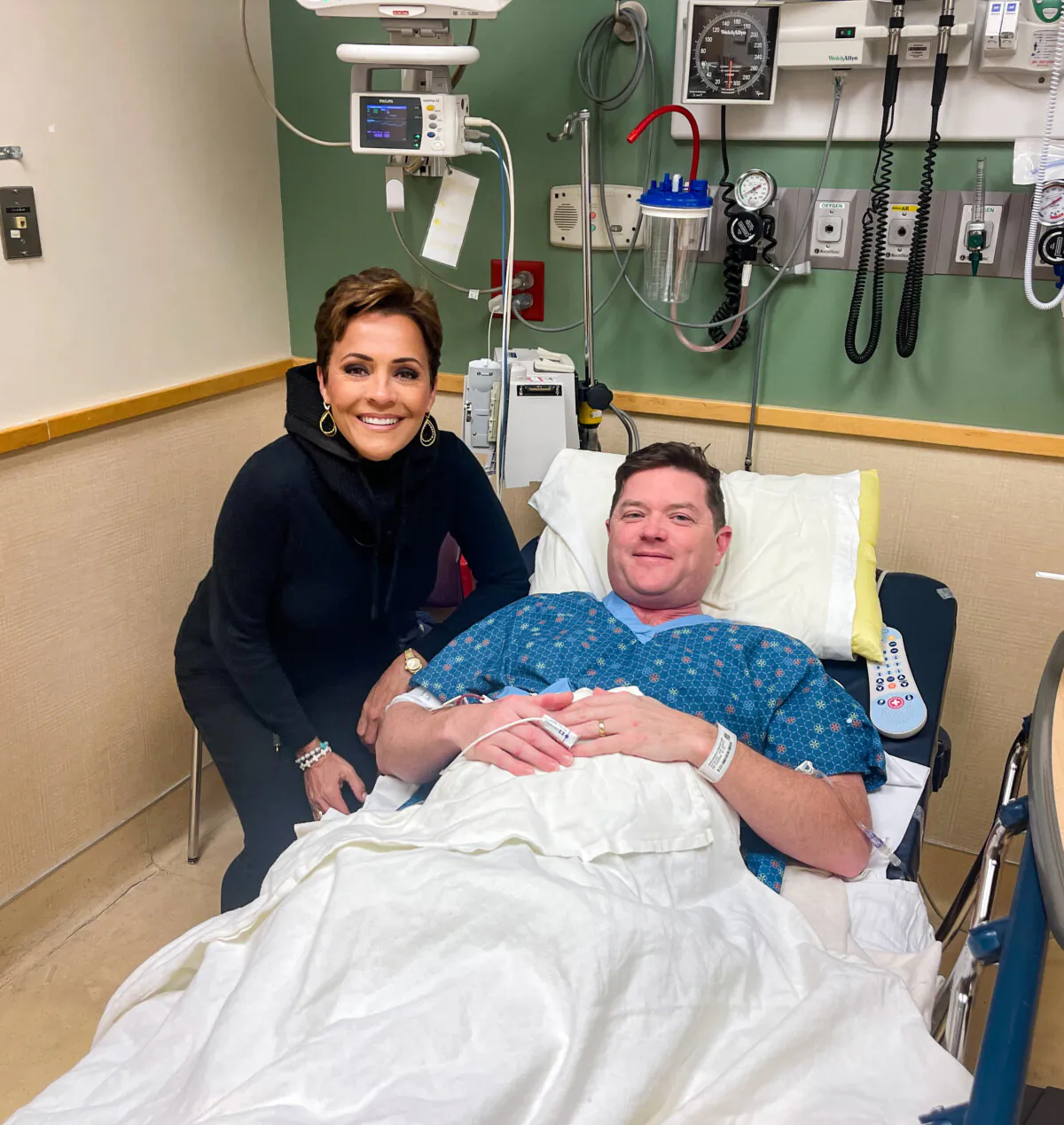 U.S. Senate hopeful Kari Lake of Arizona visits Tim Krachenfels, a fellow supporter of former President Donald Trump, at his hospital bed at MercyOne Des Moines Medical Center in Des Moines, Iowa, on Jan. 13, 2024. (Courtesy of Tim Krachenfels)