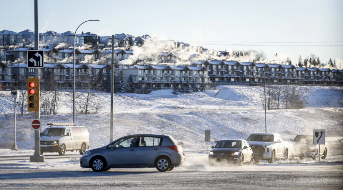 Traffic passes a neighbourhood in Calgary during frigid temperatures on Jan. 13, 2024.  (The Canadian Press/Jeff McIntosh)