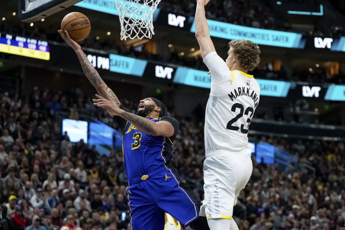 Los Angeles Lakers forward Anthony Davis (3) goes for a layup past Utah Jazz forward Lauri Markkanen (23) during the first half of an NBA basketball game in Salt Lake City on Jan. 13, 2024. (Spenser Heaps/AP Photo)