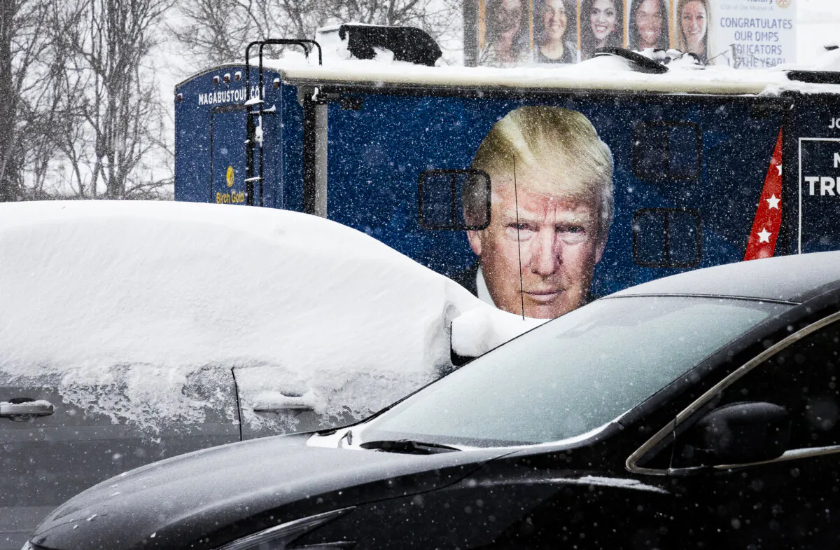 A photo of Former President Donald Trump sits on the side of an R.V during a winter storm in Des Moines, Iowa, on Jan. 12, 2024. (John Fredricks/The Epoch Times)