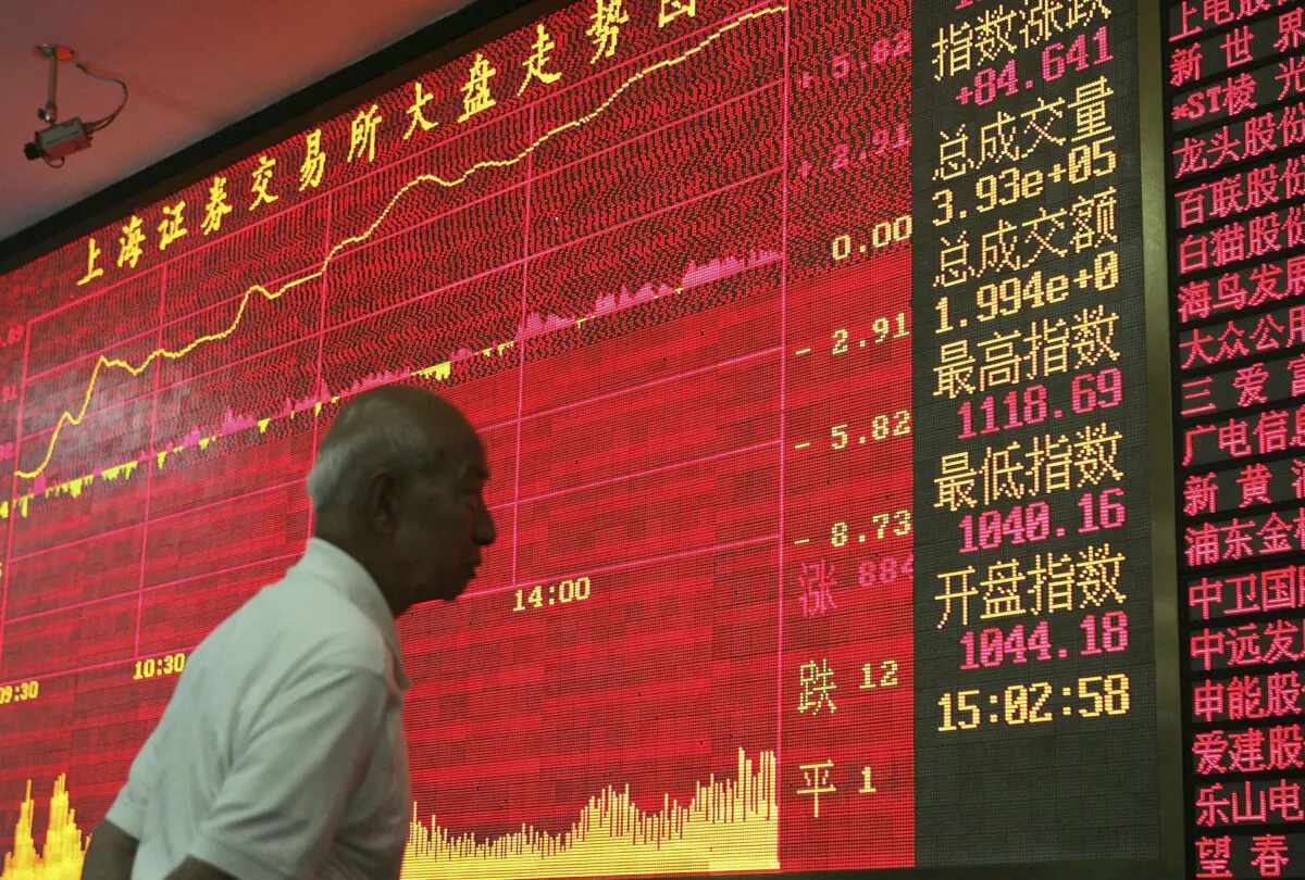 An investor looks at an electronic stock index display at a securities company in Shanghai, on June 8, 2005. (China Photos/Getty Images)