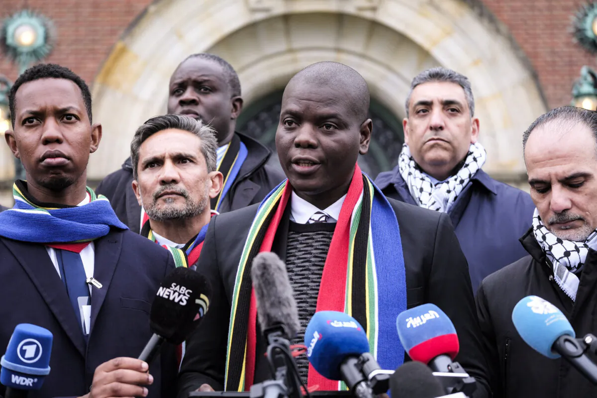 South Africa's Justice Minister Ronald Lamola (C) and Palestinian assistant Minister of Multilateral Affairs Ammar Hijazi (R) address the media outside the International Court of Justice in The Hague, Netherlands, on Jan. 11, 2024. (AP Photo/Patrick Post)