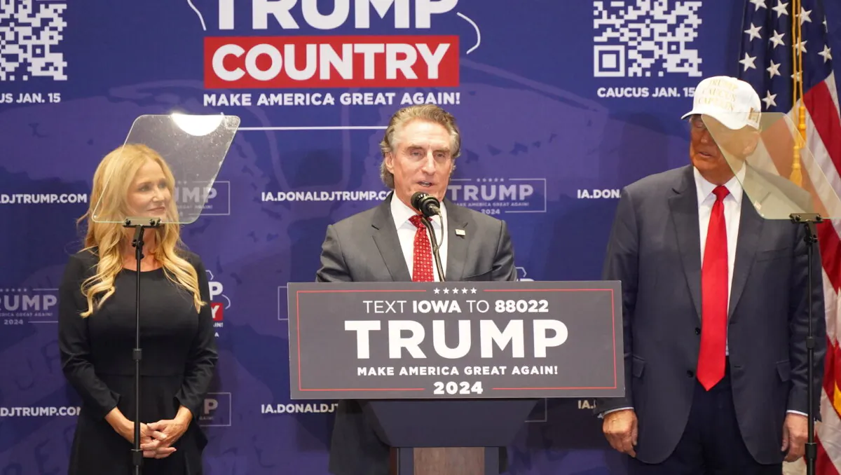 North Dakota Gov. Doug Burgum, a former 2024 Republican presidential candidate, announces his support for former President Donald Trump (R) as his wife, Kathryn, joins him onstage at a rally at Simpson College in Indianola, Iowa, on Jan. 14, 2024. (Gary Du/NTD)