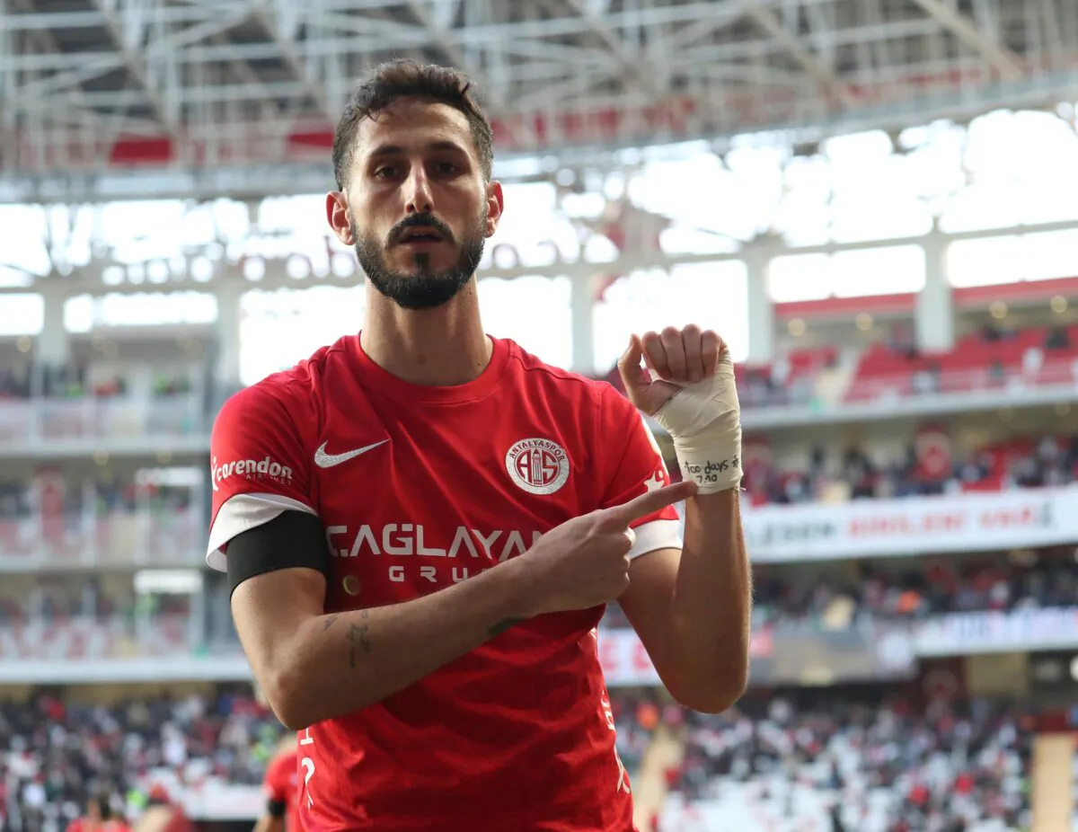 Antalyaspor's Sagiv Jehezkel points a message in his bandage that reads: "100 days. 7.10" as he celebrates after scoring his side's first goal during a Turkish Super Lig soccer match between Antalyaspor and Trabzonspor in Antalya, southern Turkey, on Jan. 14, 2024. (Adem Akalan/DHA via AP)