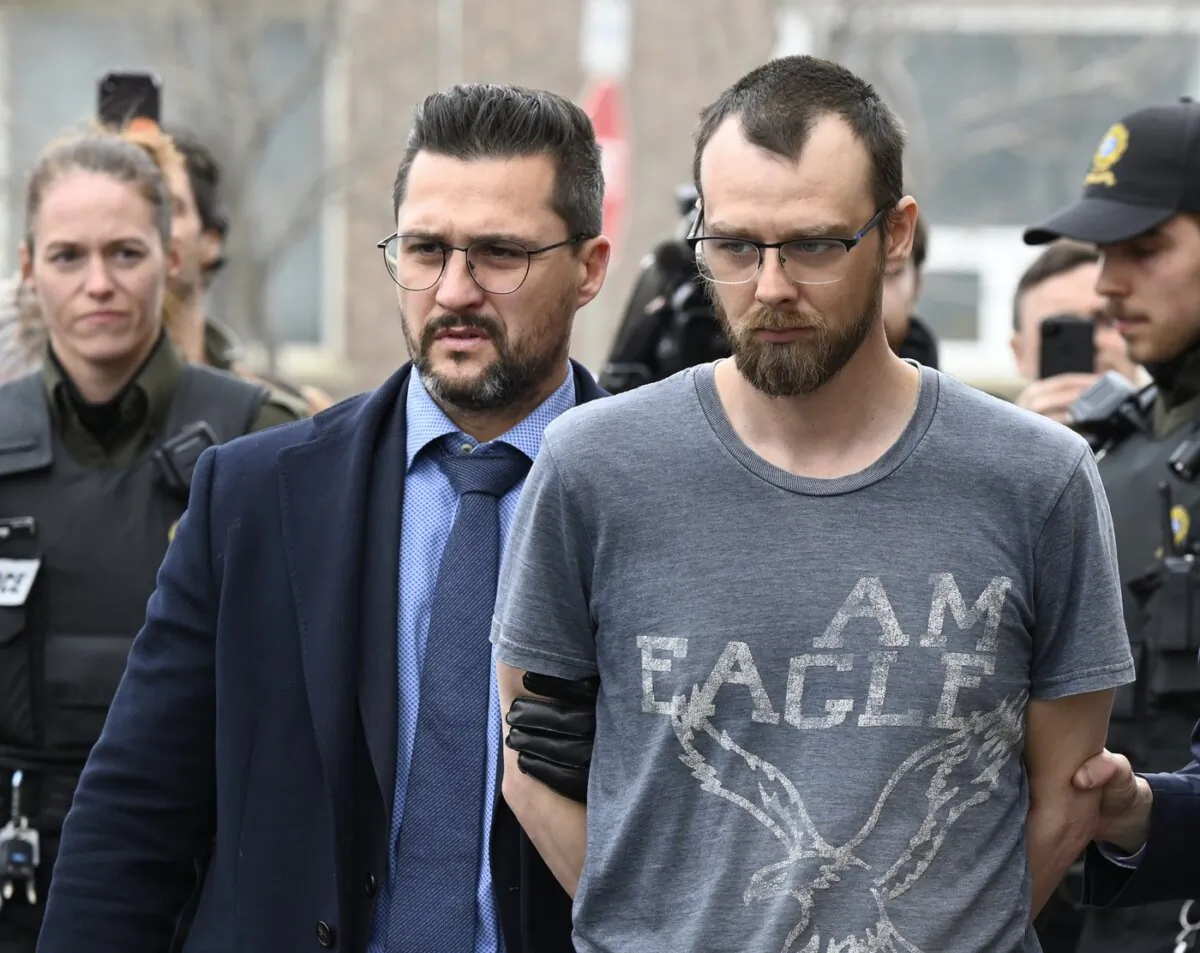 Steeve Gagnon is escorted by police out of court in Amqui, Que., on March 14, 2023. (The Canadian Press/Jacques Boissinot)