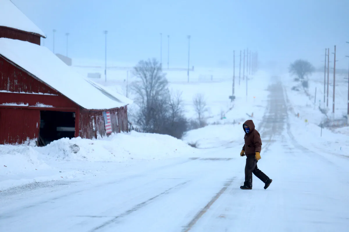 A person walks back to his home as a snowy and freezing cold weather system passes through Casey, Iowa, on Jan. 13, 2024. (Joe Raedle/Getty Images)