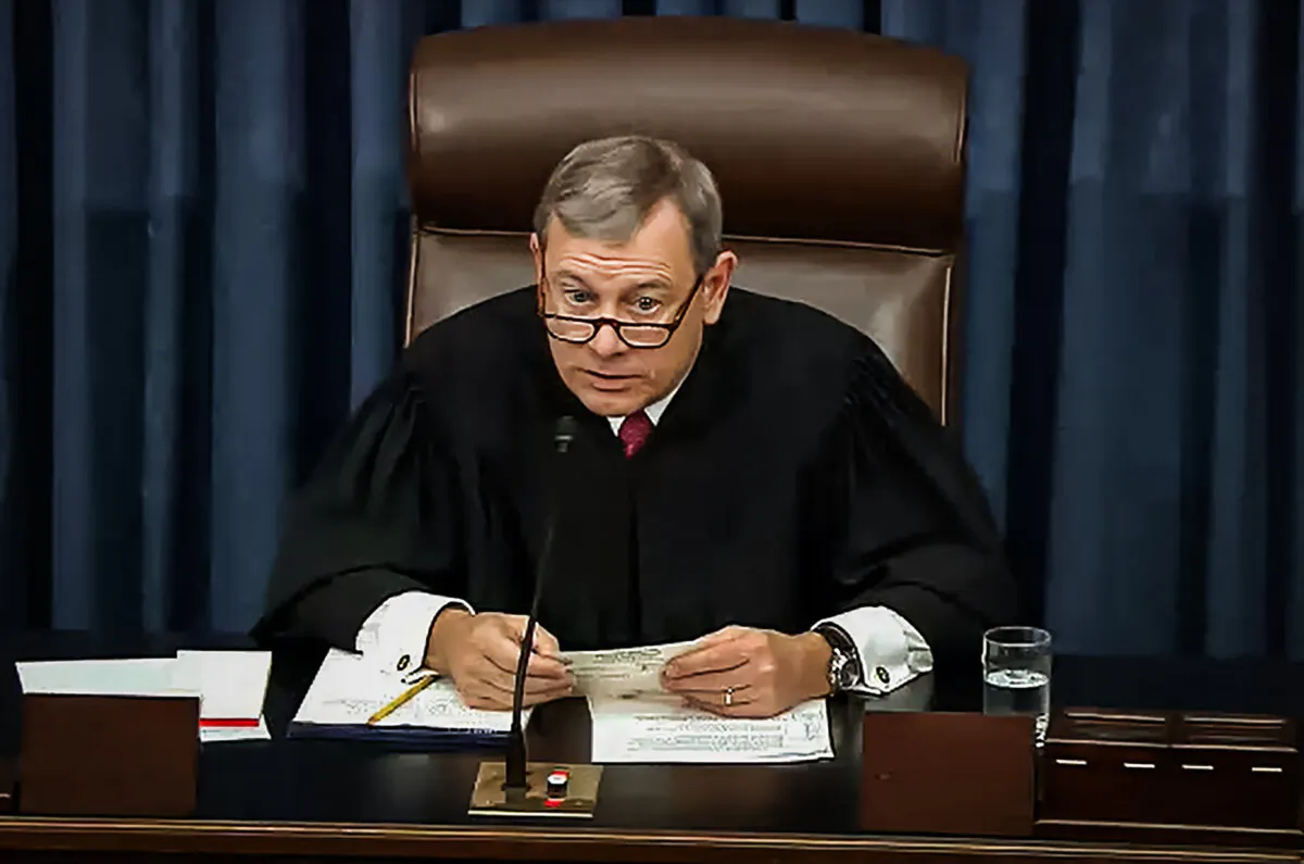 Chief Justice John Roberts reads a question from a senator during impeachment proceedings against President Donald Trump in the Senate at the U.S. Capitol on Jan. 29, 2020. (Senate Television via Getty Images)