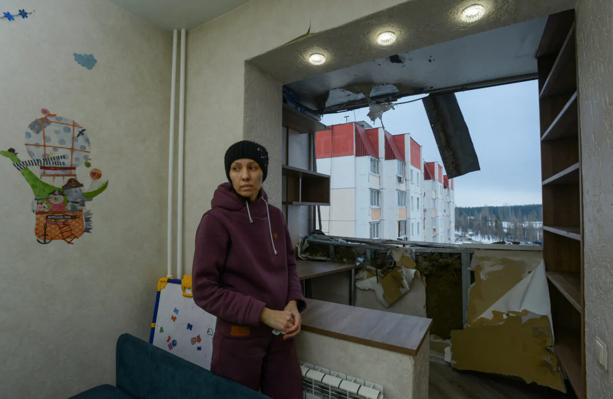 Elena Fedianinova stands in her apartment, damaged in a reported drone attack in Voronezh, Russia, on Jan. 16, 2024. (Stringer/Reuters)