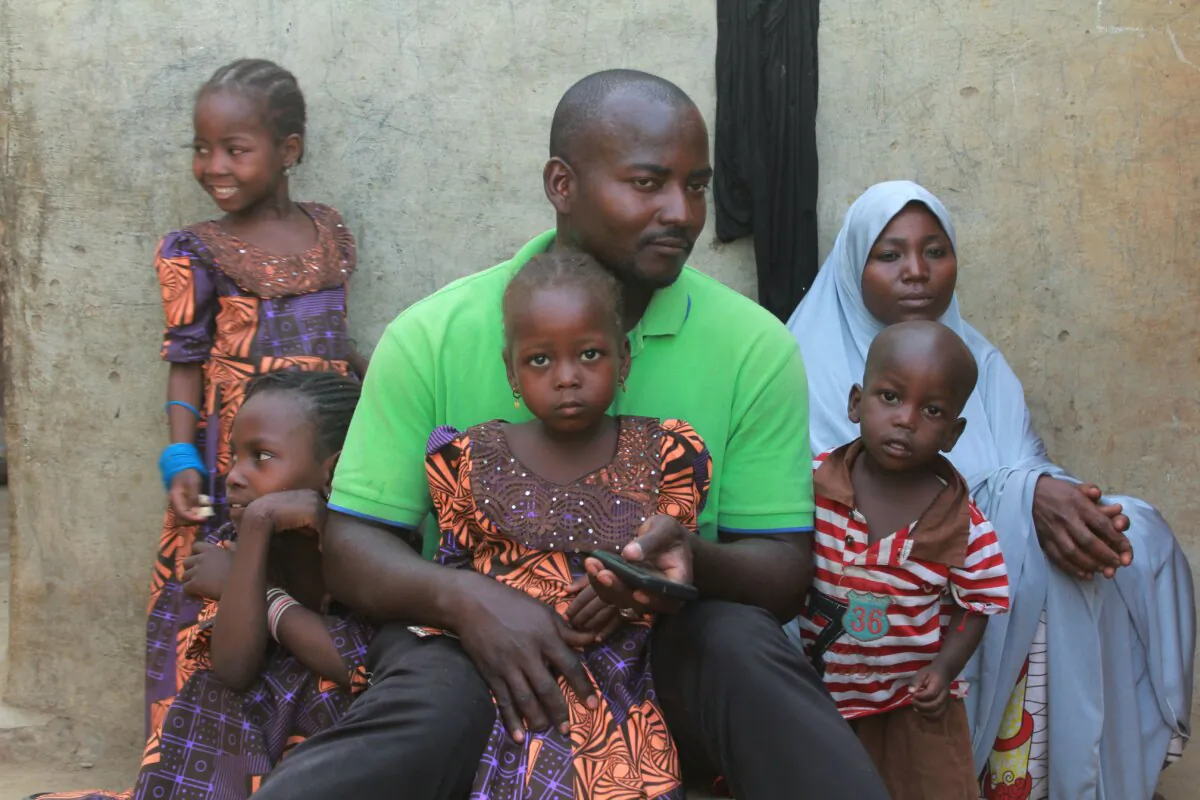 Musa Maina, father of one of the 110 schoolgirls kidnapped by the terrorist group Boko Haram in 2018, sits with his family in Chibok, Nigeria, on April 12, 2019. In 2014, more than 200 other schoolgirls were abducted. (Audu Ali Marte/AFP/Getty Images)