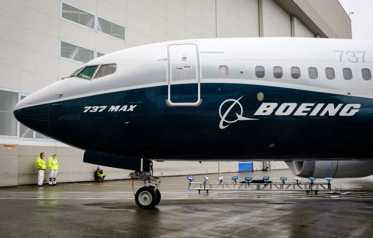 A pair of employees check out the first Boeing 737 MAX 7 in Seattle, Wash., on Feb. 5, 2018. (Stephen Brashear/Getty Images)