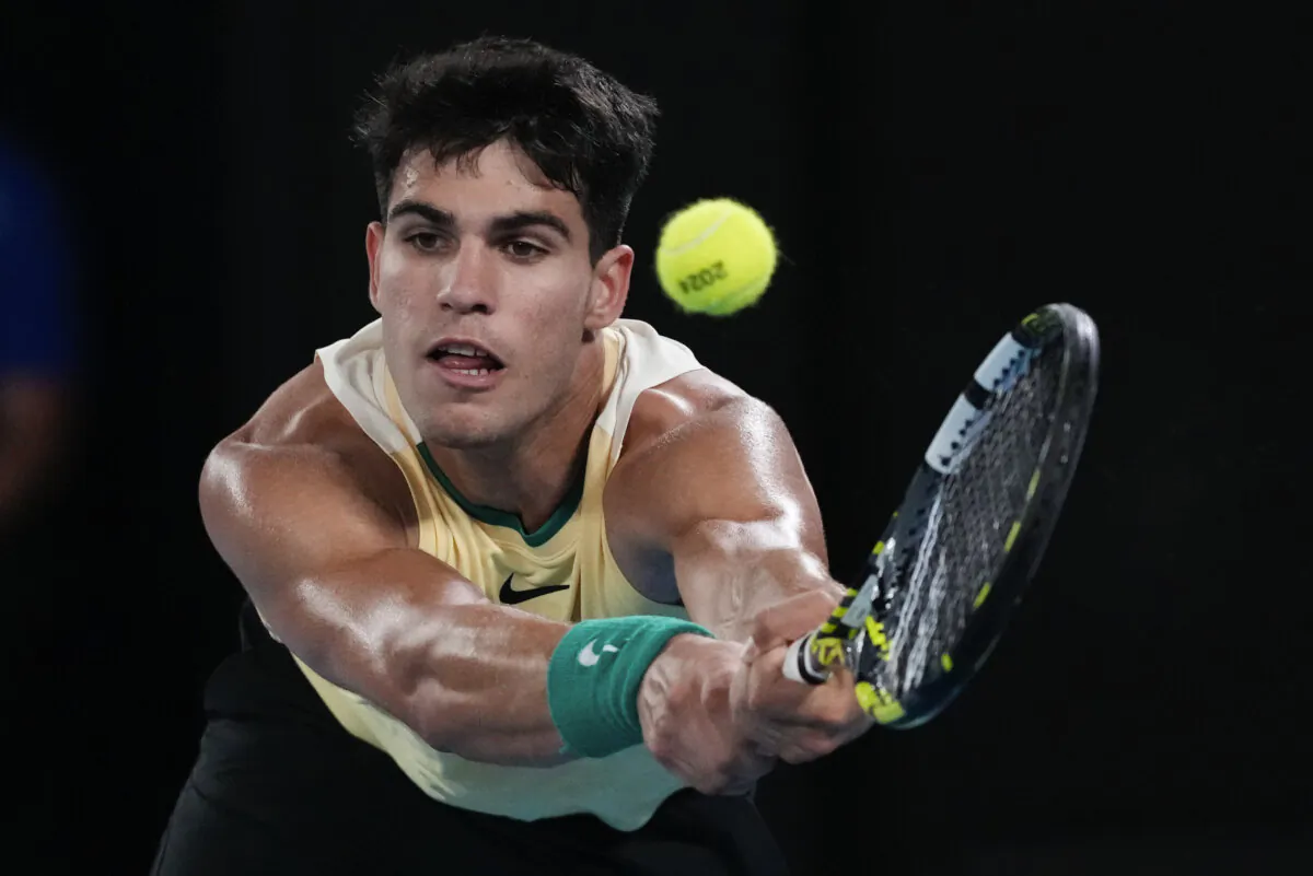 Carlos Alcaraz of Spain plays a backhand return to Richard Gasquet of France during their first round match at the Australian Open tennis championships at Melbourne Park, Melbourne, Australia, on Jan. 16, 2024. (Andy Wong/AP Photo)