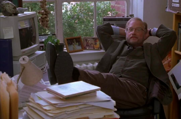 man in brown suit with feet up on desk in KRIPPENDORF'S TRIBE