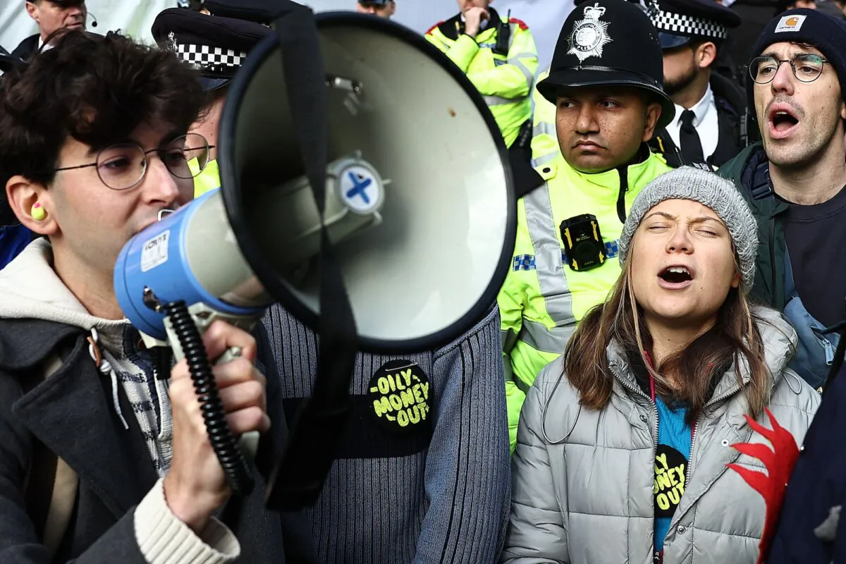 Swedish climate activist Greta Thunberg shouts slogans with fellow protesters outside the InterContinental London Park Lane during the "Oily Money Out" demonstration organised by Fossil Free London and Greenpeace on the sidelines of the opening day of the Energy Intelligence Forum 2023 in London on Oct. 17, 2023. (Henry Nicholls/AFP via Getty Images)