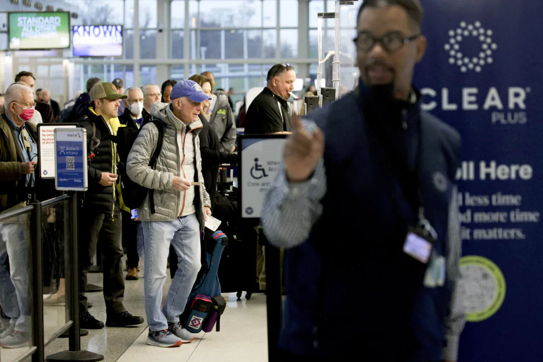 Passengers wait in line for security check at Ronald Reagan Washington National Airport in Arlington, Virginia, on Nov. 21, 2023. (Photo by Alex Wong/Getty Images)