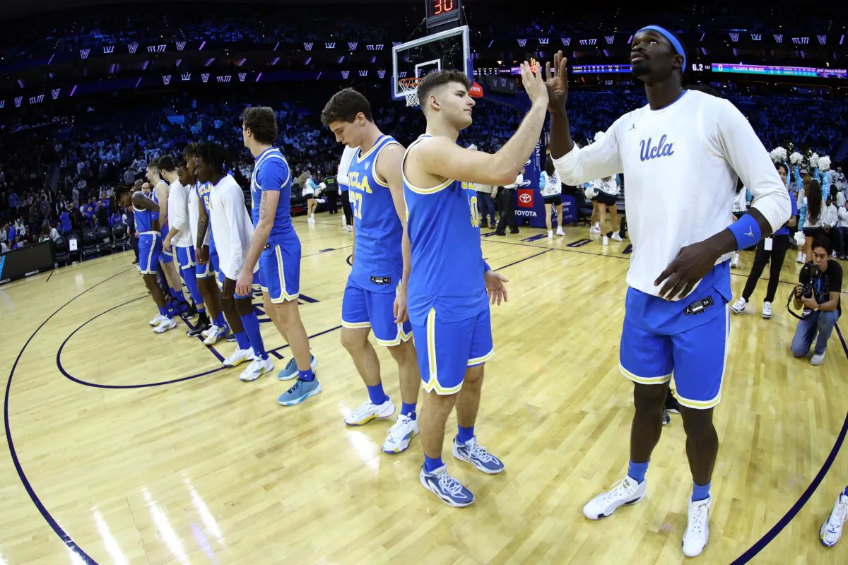 Jack Seidler (30) and Adem Bona (3) of the UCLA Bruins greet before playing against the Villanova Wildcats in Philadelphia on Dec. 9, 2023. (Tim Nwachukwu/Getty Images)