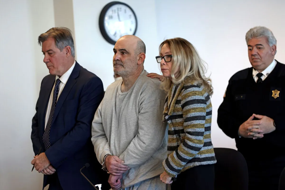Dean Kapsalis is comforted by his attorneys Jack Cunha (L), and Helen Holcomb, as his sentence is read during a hearing at Middlesex Superior Court in Woburn, Mass., on Jan. 17, 2024. (David L. Ryan/Pool/The Boston Globe via AP)