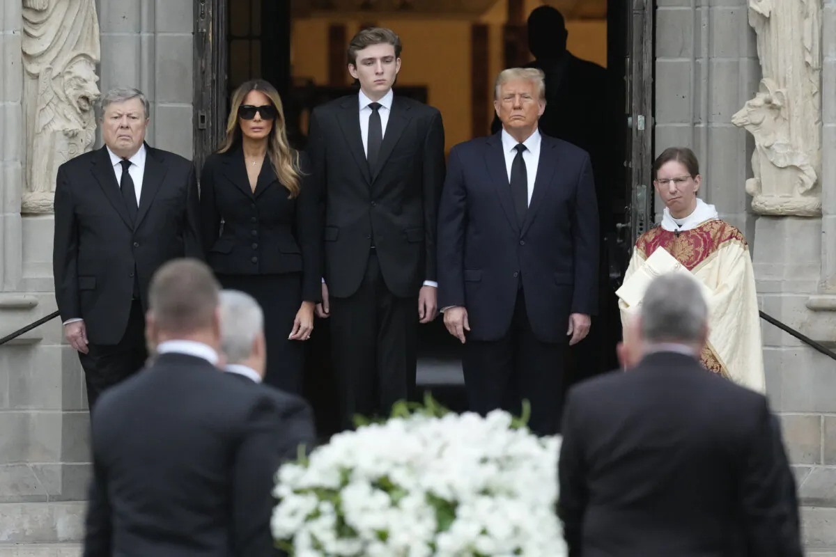 Former President Donald Trump, (center R), stands with his wife Melania, (2nd L), their son Barron, (center L), and father-in-law Viktor Knavs, as the coffin carrying the remains of Amalija Knavs, the former first lady's mother, is carried into the Church of Bethesda-by-the-Sea for her funeral, in Palm Beach, Fla., on Jan. 18, 2024. (Rebecca Blackwell/AP Photo)
