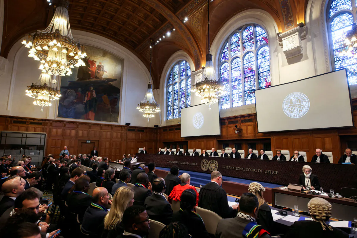 People sit inside the International Court of Justice (ICJ) on the day of the trial to hear a request for emergency measures by South Africa, who asked the court to order Israel to stop its military actions in Gaza and to desist from what South Africa says are genocidal acts committed against Palestinians during the war with Hamas in Gaza, in The Hague, Netherlands, on Jan. 11, 2024. (Thilo Schmuelgen/Reuters)