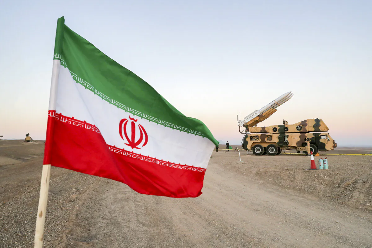 An Iranian flag is pictured near a missile during a military drill involving Iran’s Air Defense units in Iran on Oct. 19, 2020. (West Asia News Agency via Reuters)