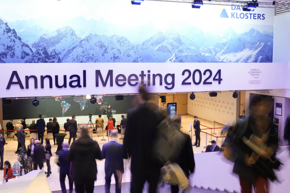 People walk down the stairs at the Congress Hall during the World Economic Forum in Davos, Switzerland, on Jan. 18, 2024. The annual meeting of the World Economic Forum is taking place in Davos from Jan. 15 until Jan. 19, 2024. (AP Photo/Markus Schreiber)