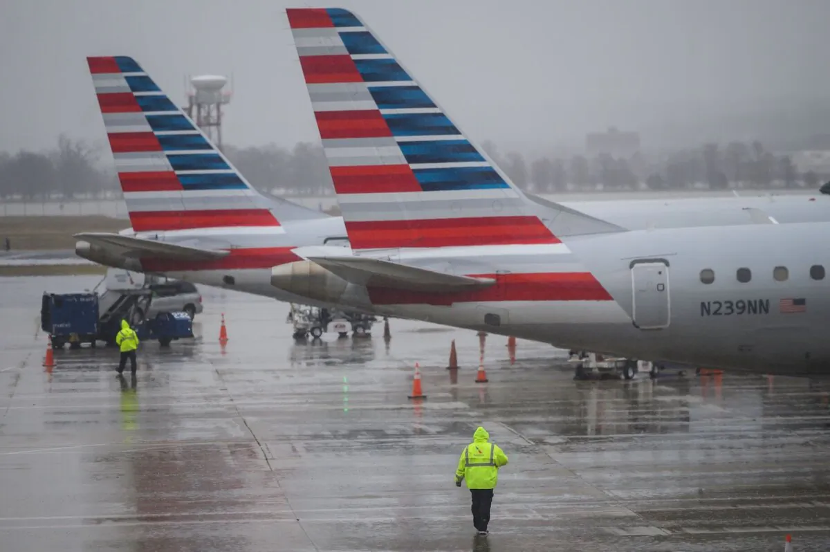 An American Airlines ground staff member walks towards planes on the tarmac at Ronald Reagan Washington National Airport in Arlington, Va., on Jan. 24, 2019. (Andrew Caballero-Reynolds/AFP via Getty Images)