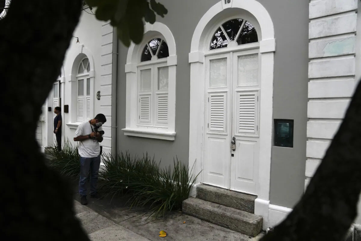 A journalist films the entrance to the apartment where Brent Sikkema, an American art dealer, was found dead, in Rio de Janeiro, Brazil, Thursday, Jan. 18, 2024. The 75-year-old owner of a gallery in Manhattan was found stabbed to dead on Monday. (AP Photo/Silvia Izquierdo)