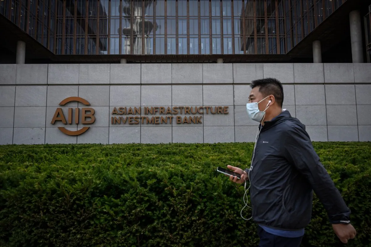 A man walks past the Asian Infrastructure Investment Bank's headquarters in Beijing on June 15, 2023. (Jade Gao/AFP via Getty Images)