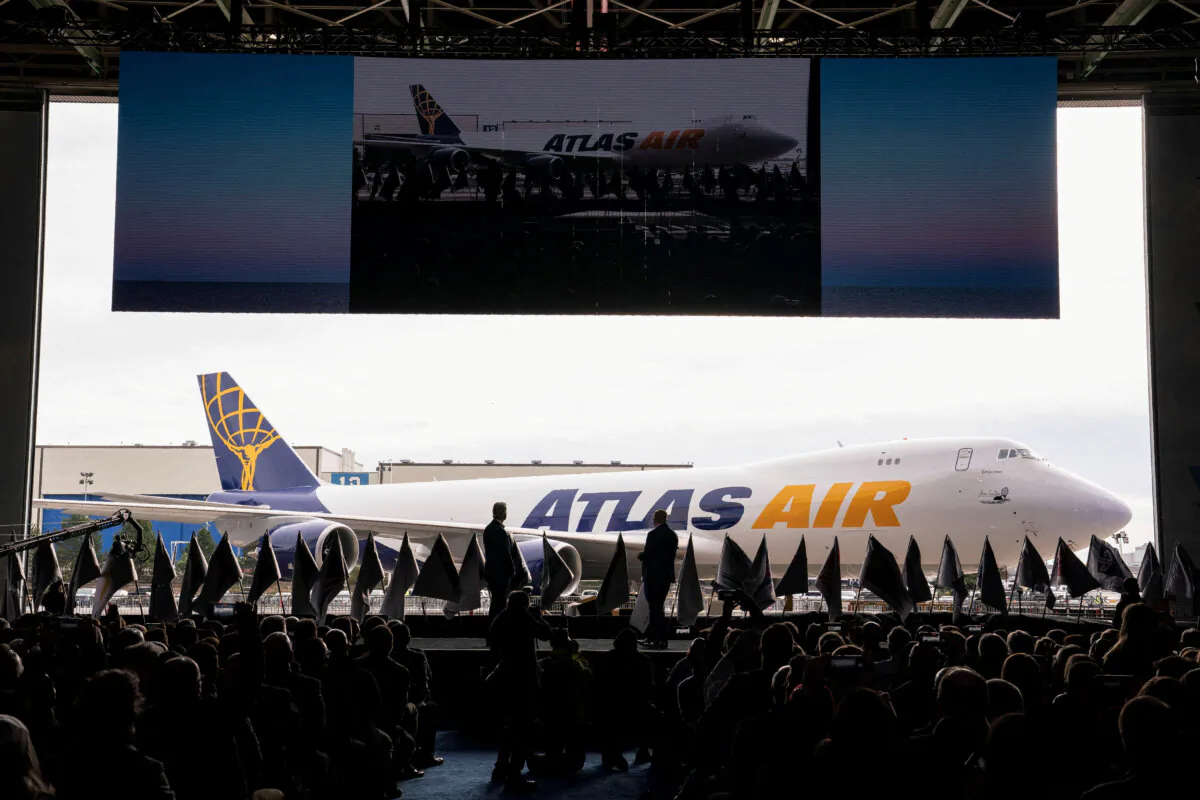 John W. Dietrich, president and CEO of Atlas Air Worldwide, and Dave Calhoun, CEO of Boeing, converse on stage during the delivery of the final 747 jet at their plant in Everett, Washington, on Jan. 31, 2023. (David Ryder/Reuters)
