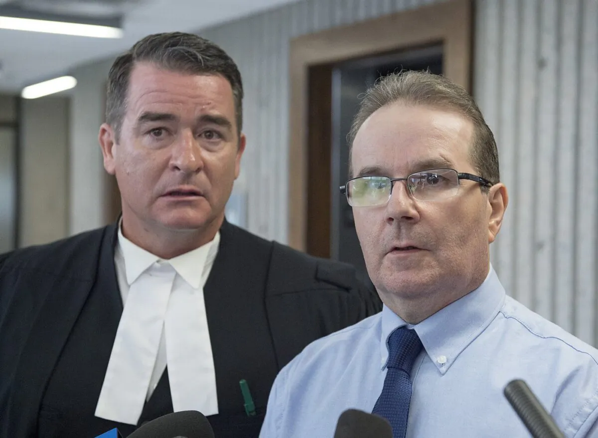Glen Assoun (R), the Nova Scotia man who spent almost 17 years in prison for a murder he didn't commit, and his defence lawyer Sean MacDonald talk to reporters outside Supreme Court in Halifax on July 12, 2019. (The Canadian Press/Andrew Vaughan)