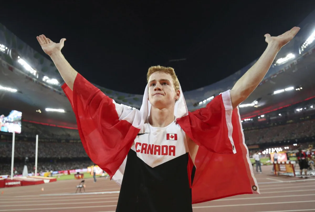 Canada's Shawn Barber celebrates after winning the gold medal in the men's pole vault final at the World Athletics Championships at the Bird's Nest stadium in Beijing on Aug. 24, 2015. (Christian Charisius/dpa via AP)