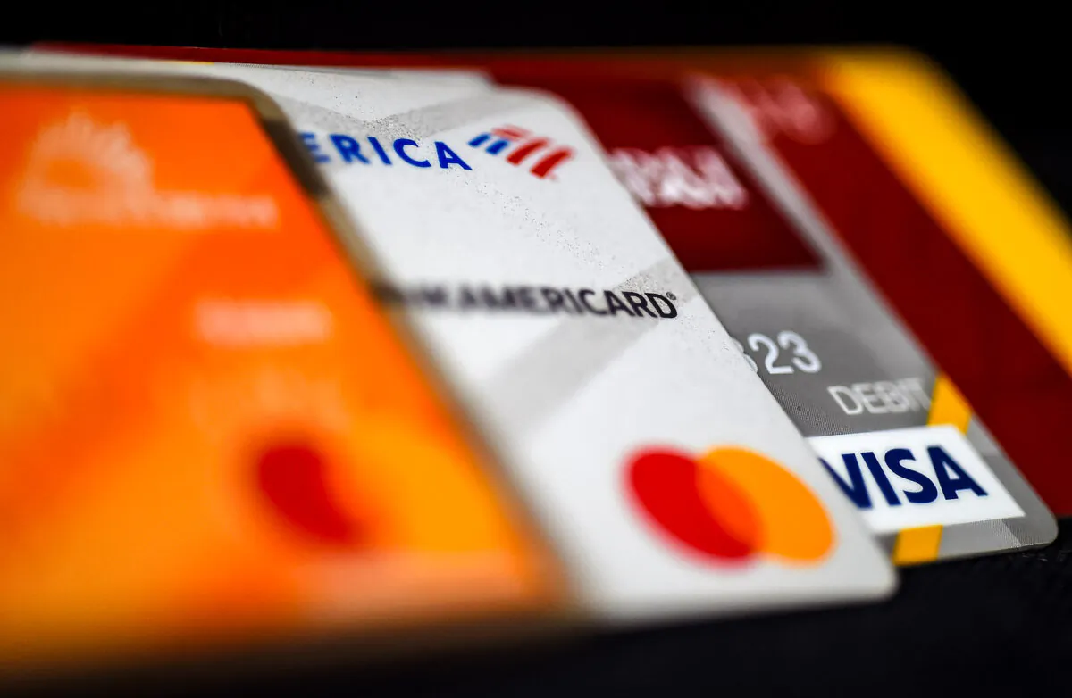 This illustration picture shows debit and credit cards arranged on a desk in Arlington, Va. on April 6, 2020. (Olivier Douliery/AFP via Getty Images)