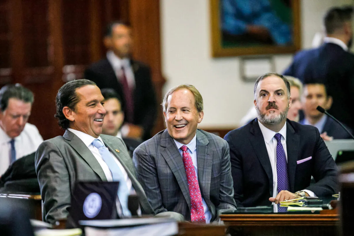 Texas Attorney General Ken Paxton, center, sits between defense attorneys Tony Buzbee, left, and Mitch Little, right, before his impeachment trial resumes in the Senate Chamber at the Texas Capitol on Friday, Sept. 15, 2023, in Austin, Texas. (Sam Owens/The San Antonio Express-News via AP, Pool)
