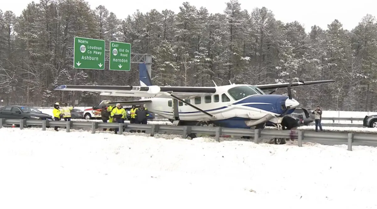 Emergency personnel investigate a small plane on a roadway in Loudoun County, Va., on Jan. 19, 2024. (WJLA via AP)