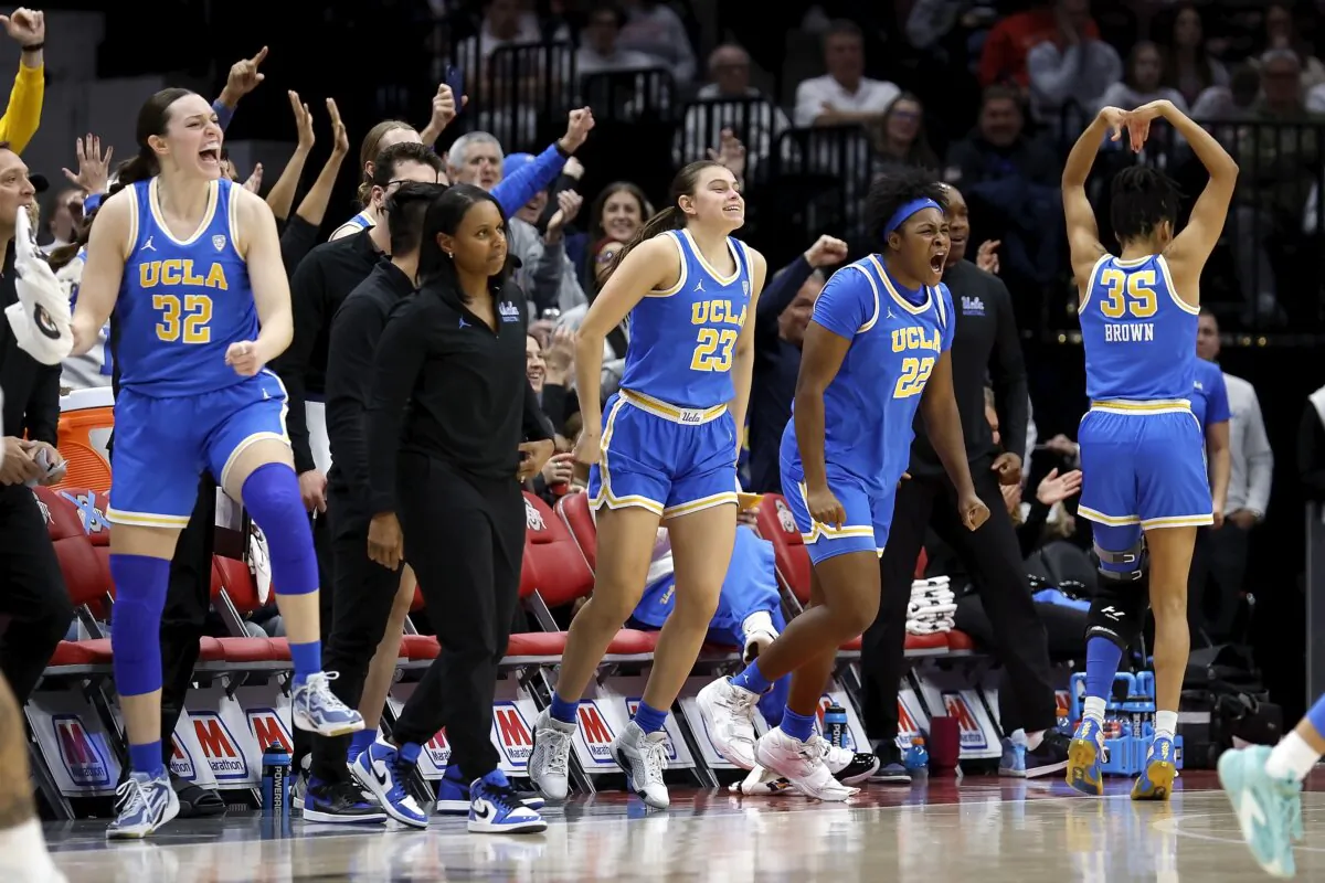 Christeen Iwuala (22) of the UCLA Bruins Gabriela Jaquez (23) and Angela Dugalic (32) react after a teammate makes a basket during third quarter of the game against the Ohio State Buckeyes in Columbus, Ohio, on Dec. 18, 2023. (Kirk Irwin/Getty Images)