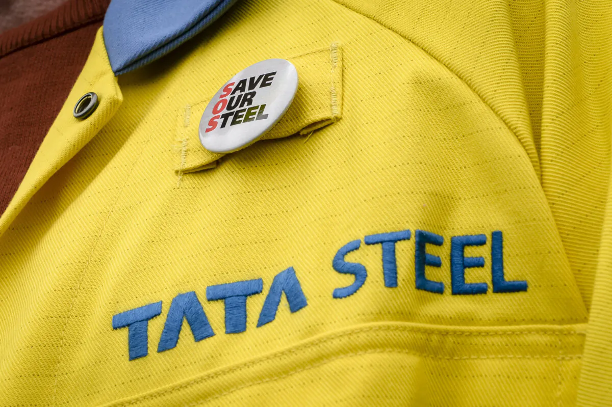 A steel worker wearing a badge on his jacket outside the UK's largest steel works in Port Talbot, South Wales, on April, 1, 2016. (PA)