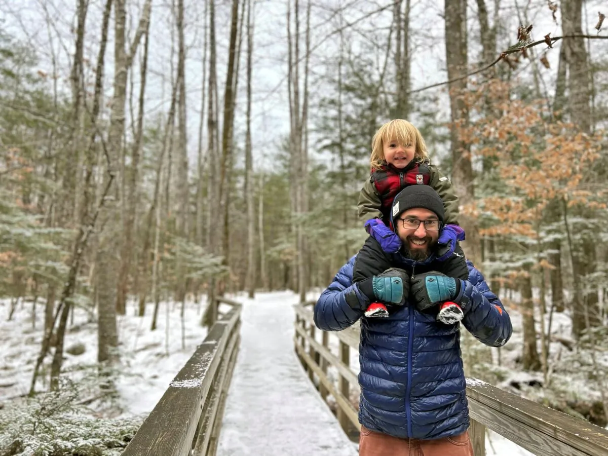 Christopher Roma carries his son Solomon on his shoulders in the White Mountains, N.H., in late 2023. (Megan Roma Sullivan via AP)
